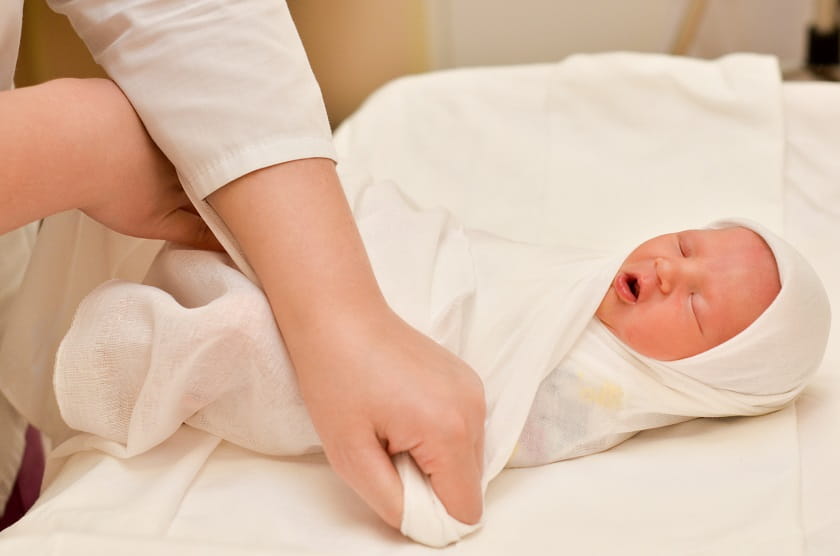 newborn baby in the delivery room the first hours of life swaddling - Roll Up Baby